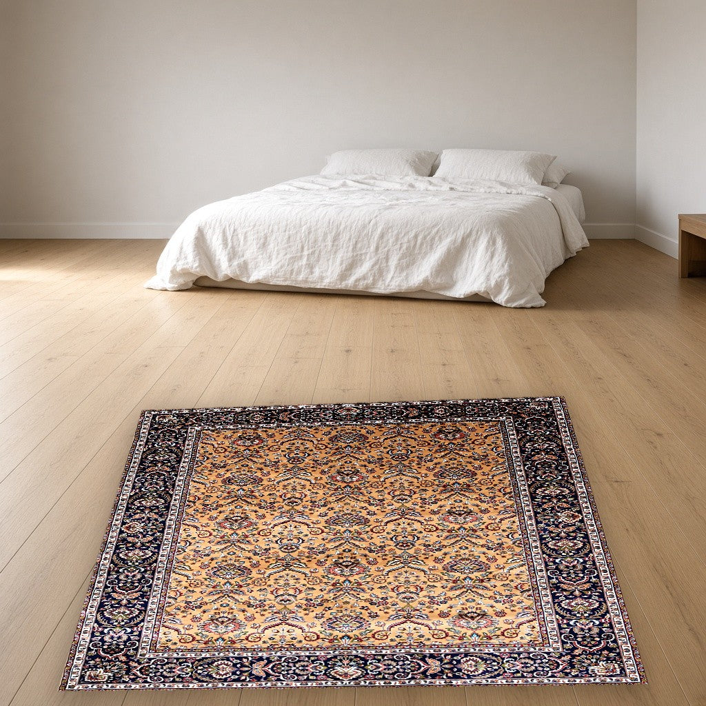 Gold Navy Garden Border Floral Mogul Area Rug in a bedroom