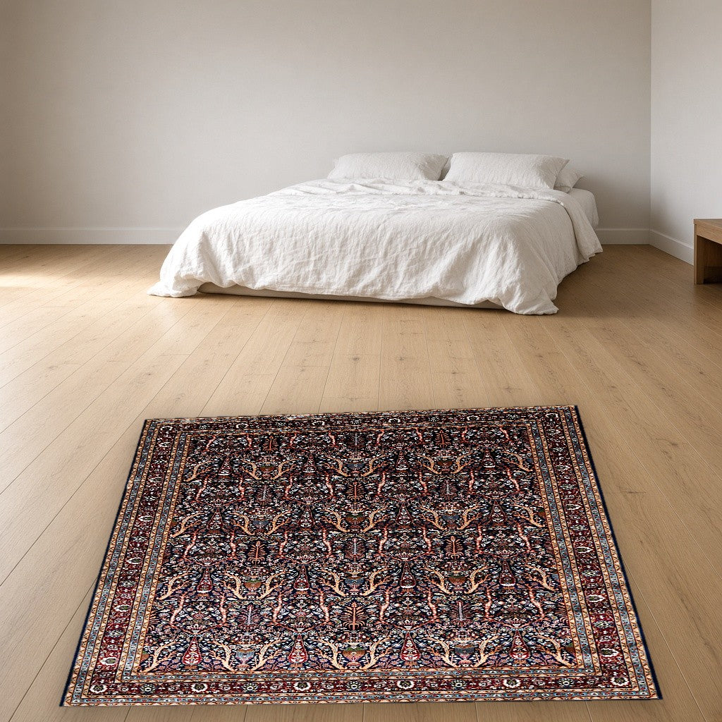 Navy Dense Floral Palace Mogul Area Rug in a bedroom