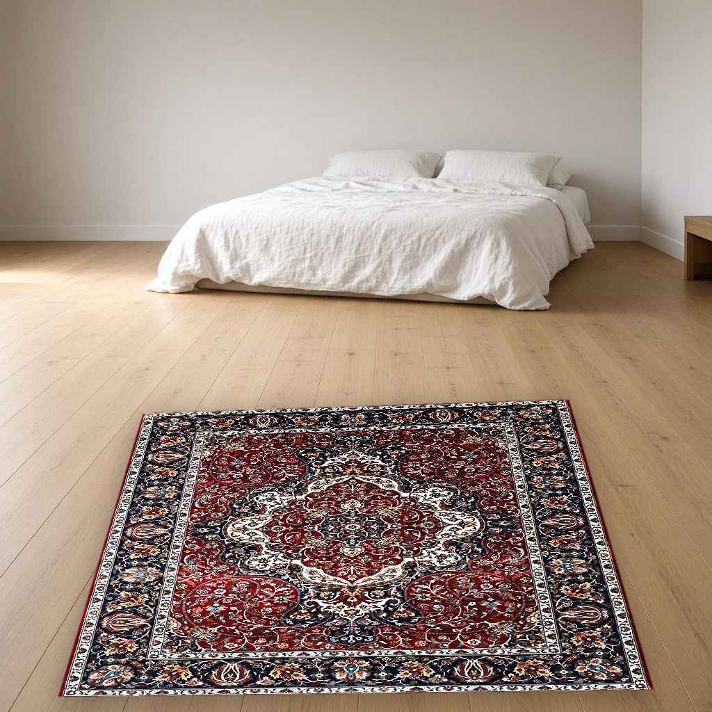 Red Navy Jewel Tone Floral Mogul Area Rug in a bedroom